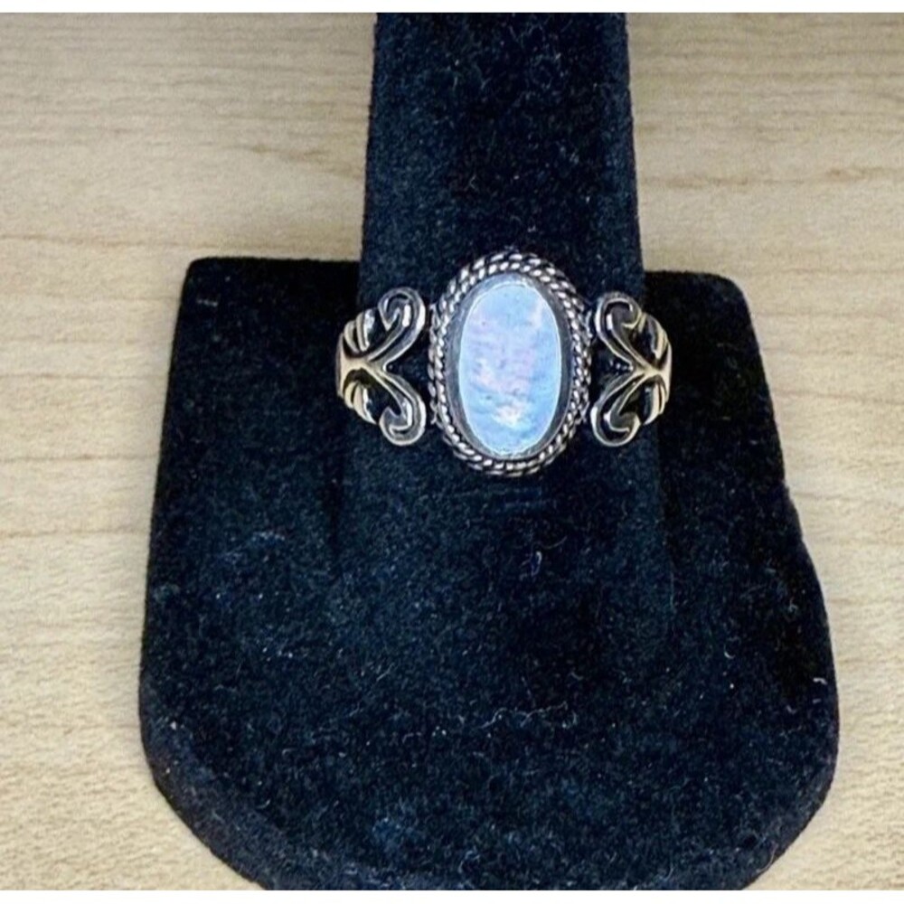 Vintage sterling silver and mother of pearl swirl designed frame oval statement